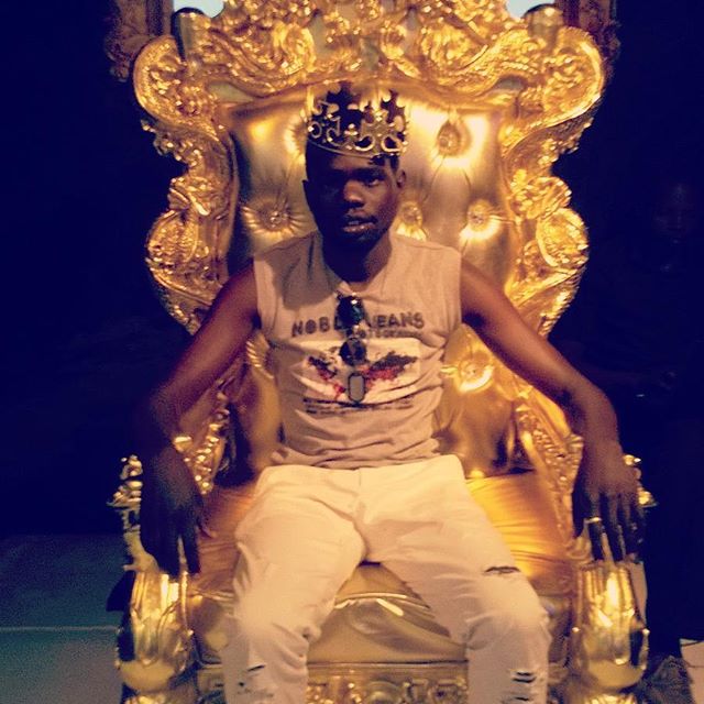 G Kon sitting on a throne