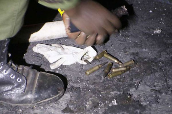 An officer picking up rounds of ammunition from the ground | photo courtesy of Suleiman Mbatiah