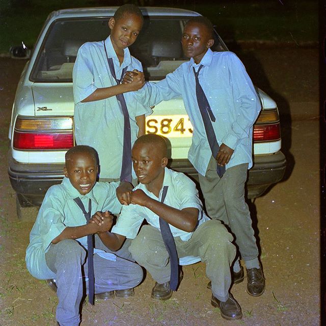 young Boniface Mwangi with friends in high school | Instagram