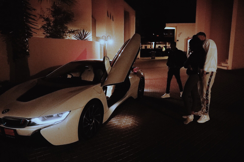 AKA with Bonang Mathemba in front of his BMW i8 via Twitter