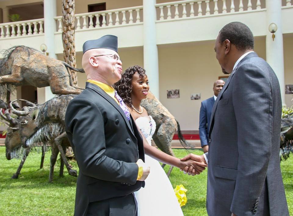 Isaac Mwaura and his wife together with President Uhuru Kenyatta on their wedding day