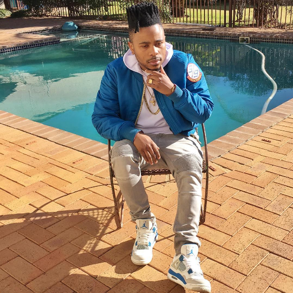 L-Tido rocking white and blue colorway Air Jordan 4s