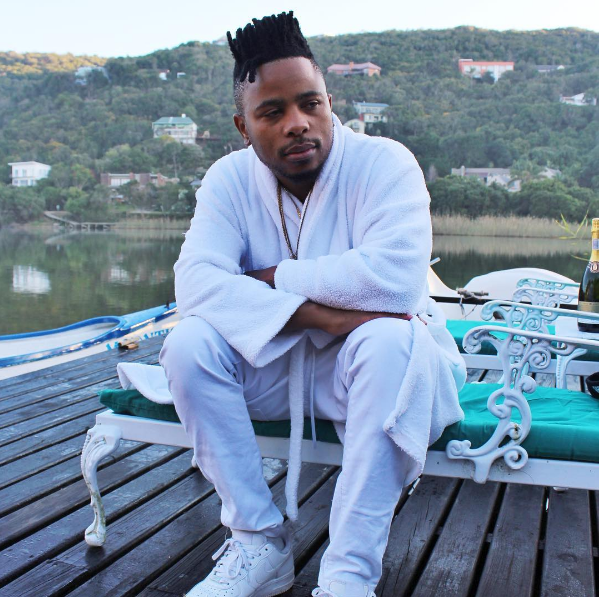 L-Tido wearing whie Nike Air Force 1 low tops