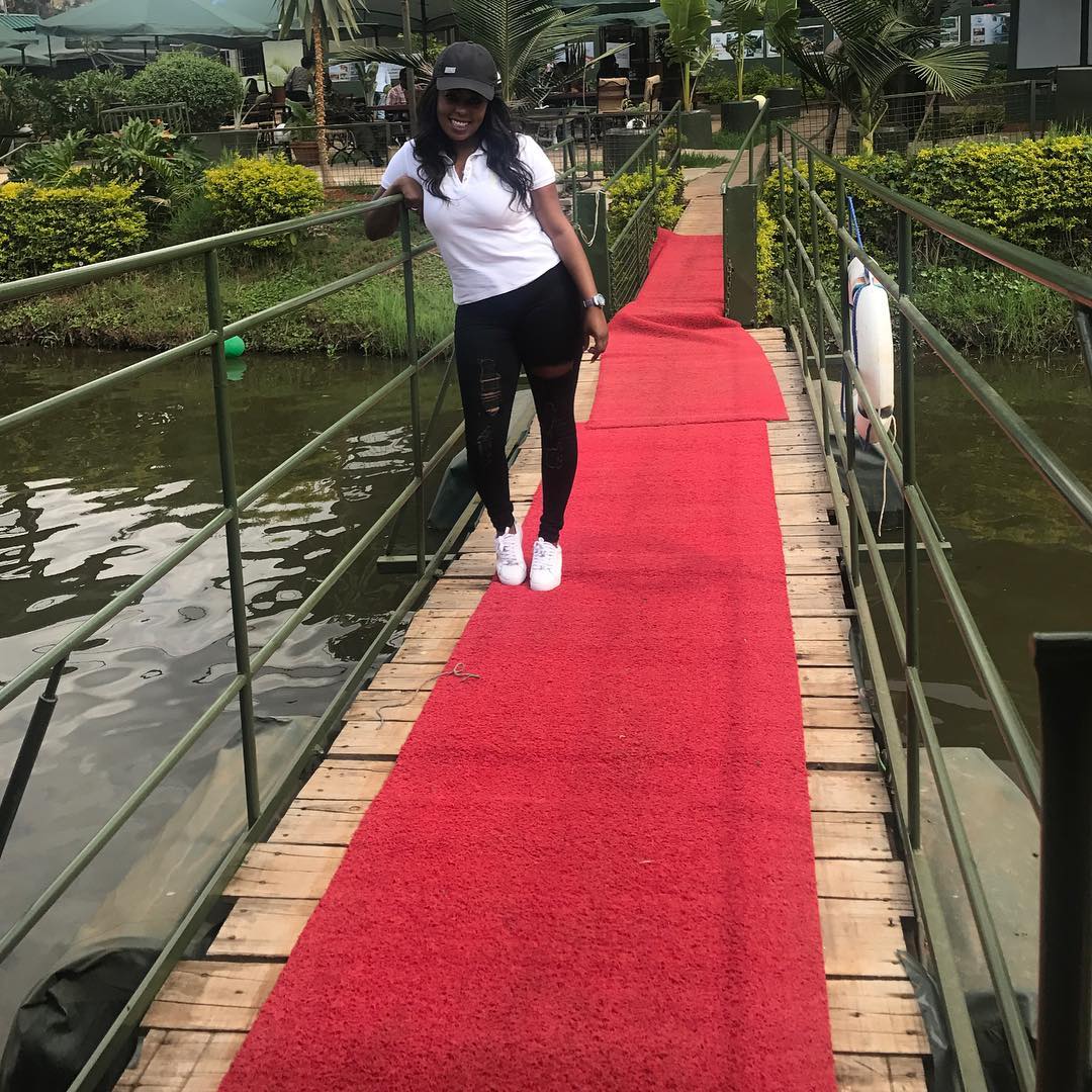 Lillian Muli looking good in white T-shirt, black jeans with white Stan Smith sneakers
