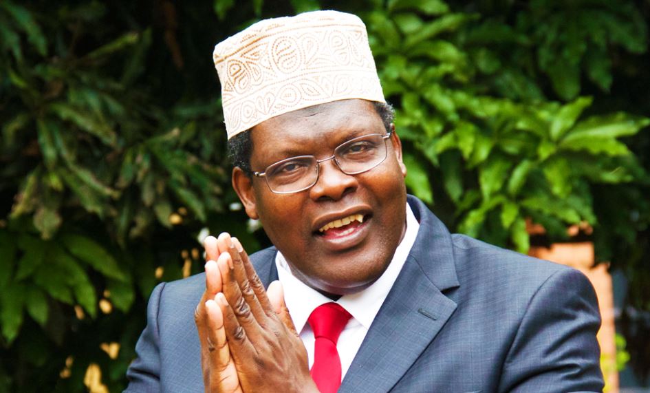 Miguna Miguna clasping hands