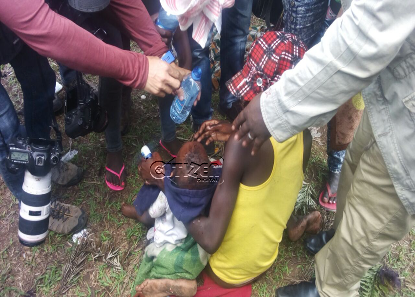 journalists helping mother and child