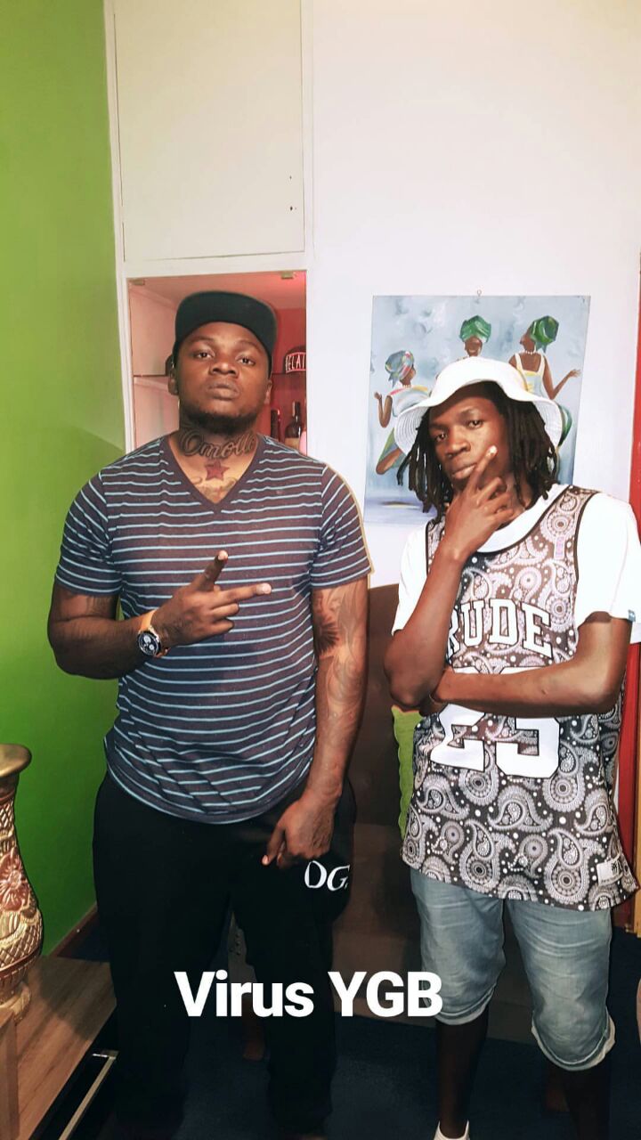 Khaligraph Jones showing off his 'Omollo' tattoo with Kibera rapper Virusi Mbaya. photo credit: Instagram/khaligraph_jones
