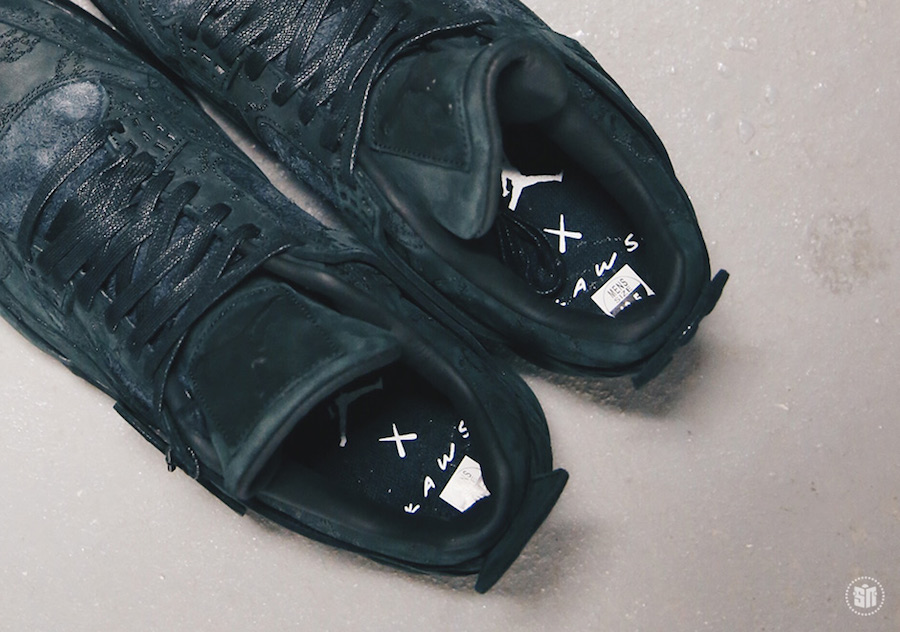 KAWS x Air Jordan 4 Black sneakers. photo credit: Sneaker News