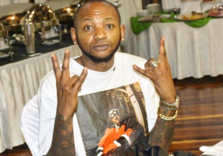 Colonel Mustafa holding the wess signe up