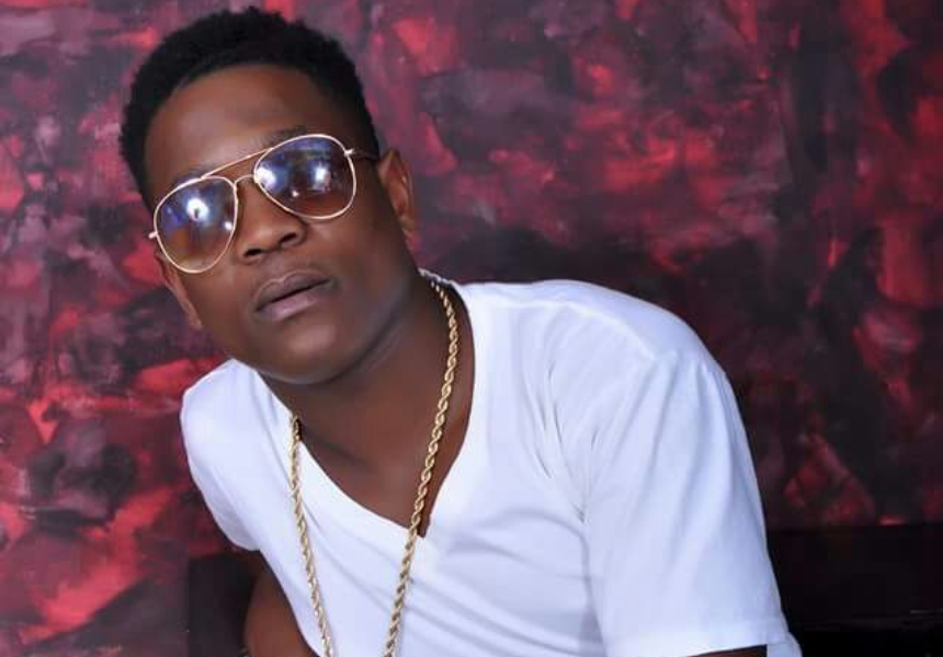 Kizo B wearing a white tee