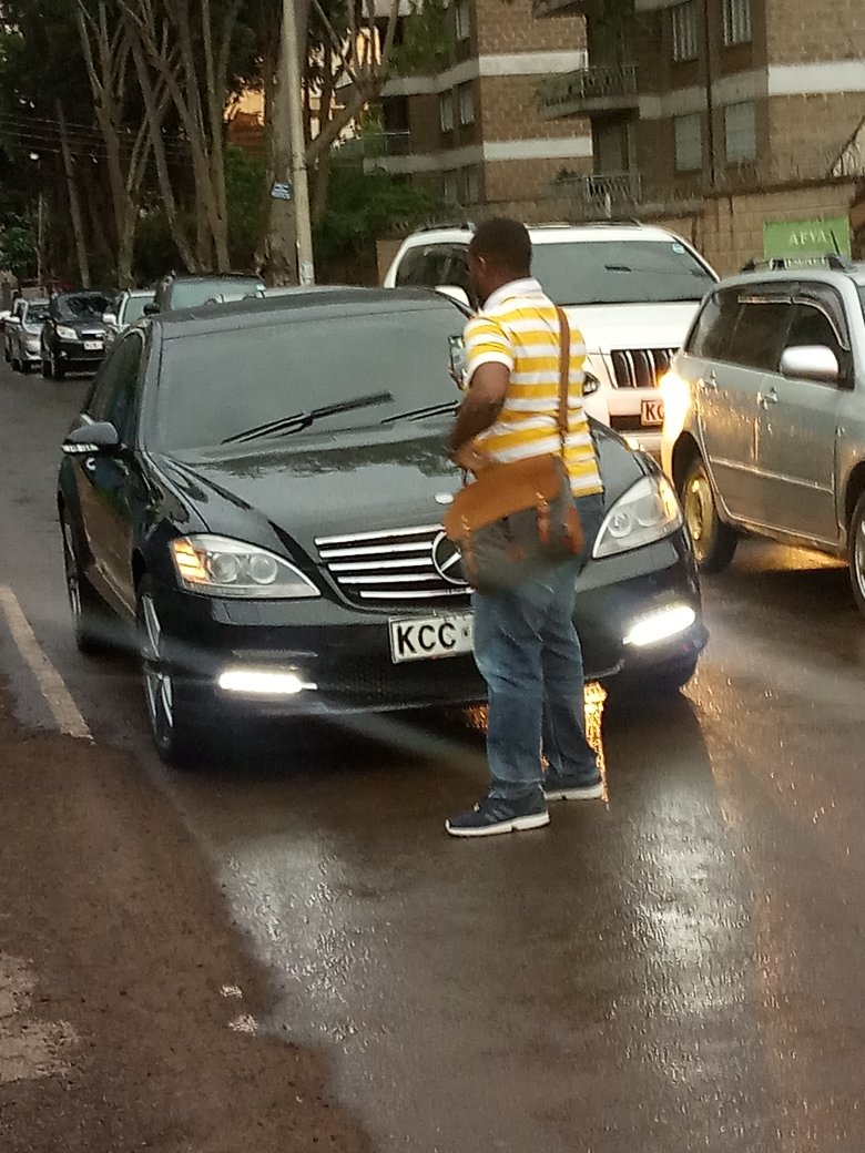 David Lemayian standing in front of a car belonging to a Member of National Assembly blocking him for overlapping. photo credit: Twitter/DavidLemayian