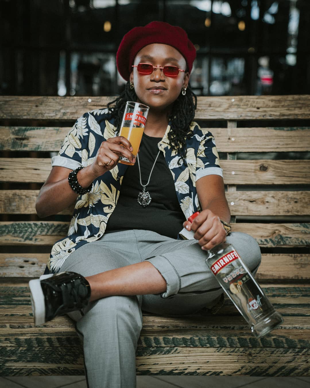 Fena Gitu posing with a bottle and a glass of Smirnoff. she's the brand ambassador for Smirnoff Kenya together with fellow rapper, Octopizzo. photo credit: Instagram/fenamenal