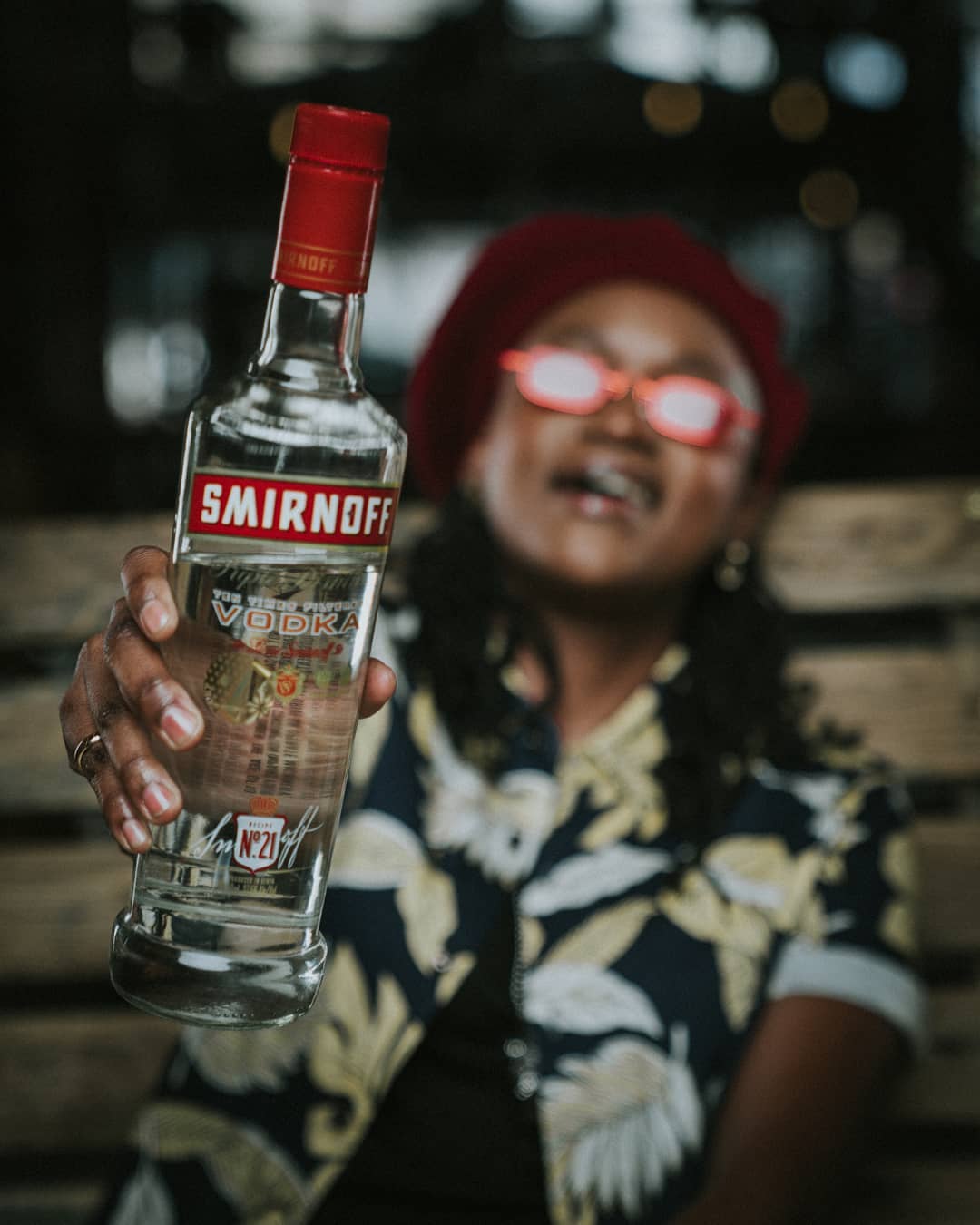 Fena Gitu posing with a Smirnoff bottle. she’s the brand ambassador for Smirnoff Kenya together with fellow rapper, Octopizzo. photo credit: Instagram/fenamenal