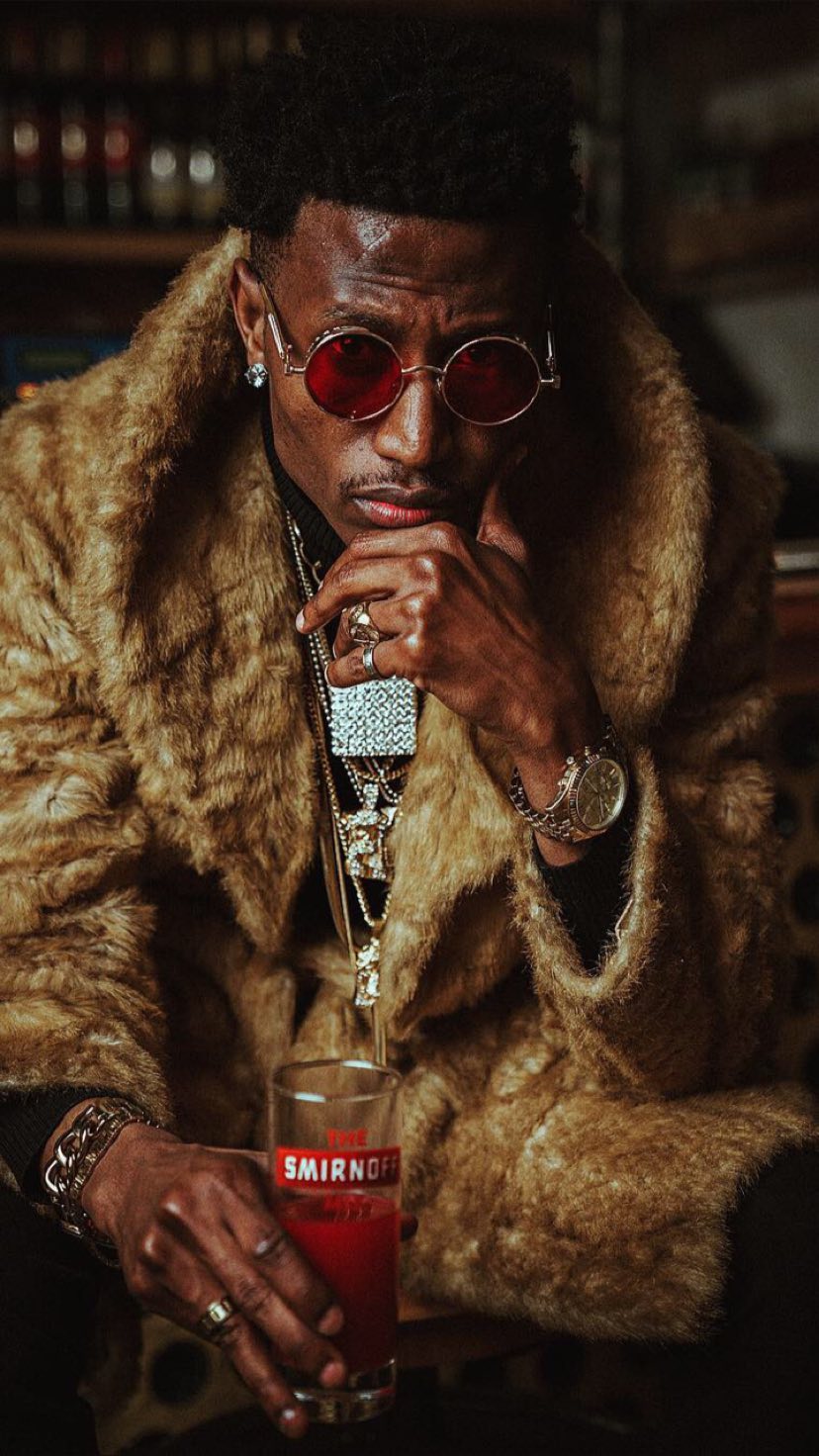 Octopizzo posing with a Smirnoff-branded glass. photo credit: Instagram/octopizzo