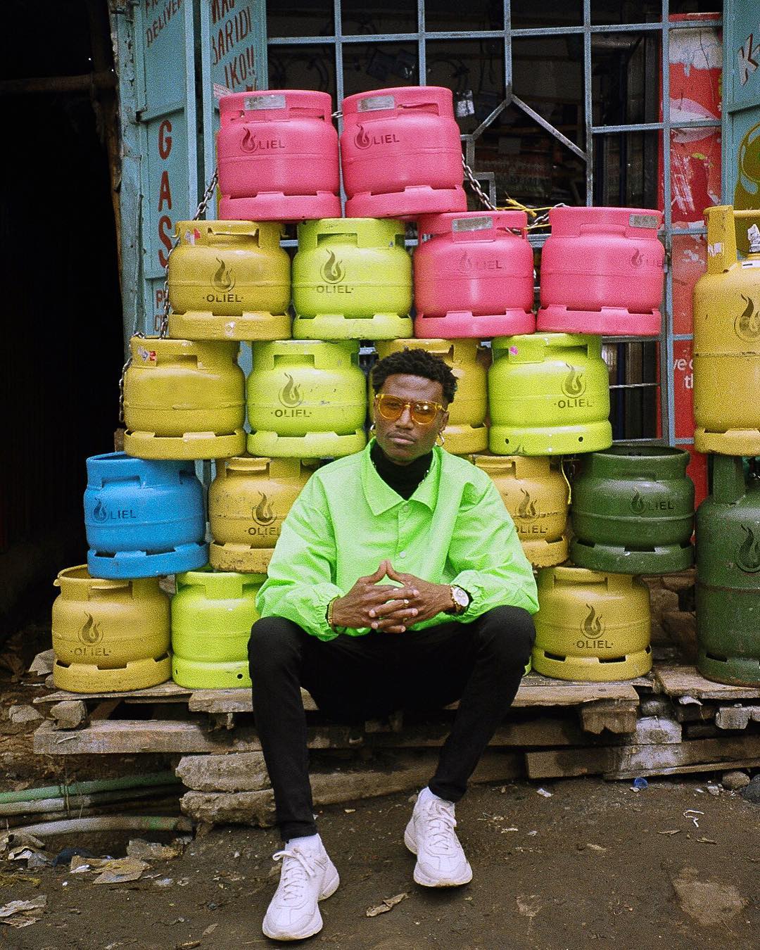Octopizzo posing in front of his 'Oliel' gas cylinders. photo credit: Instagram/octopizzo