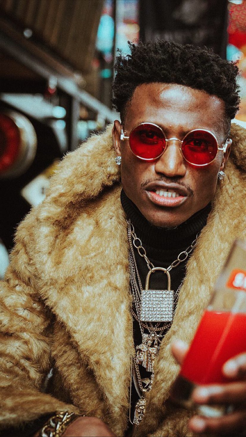 Octopizzo posing with a Smirnoff-branded glass. photo credit: Instagram/octopizzo