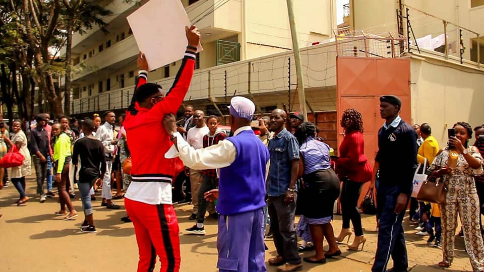 Ringtone holding his "Looking for a Wife" placard outside of Jubilee Christian Church, Parklands earlier on today. photo credit: Facebok/Ugenya Siaya Alego