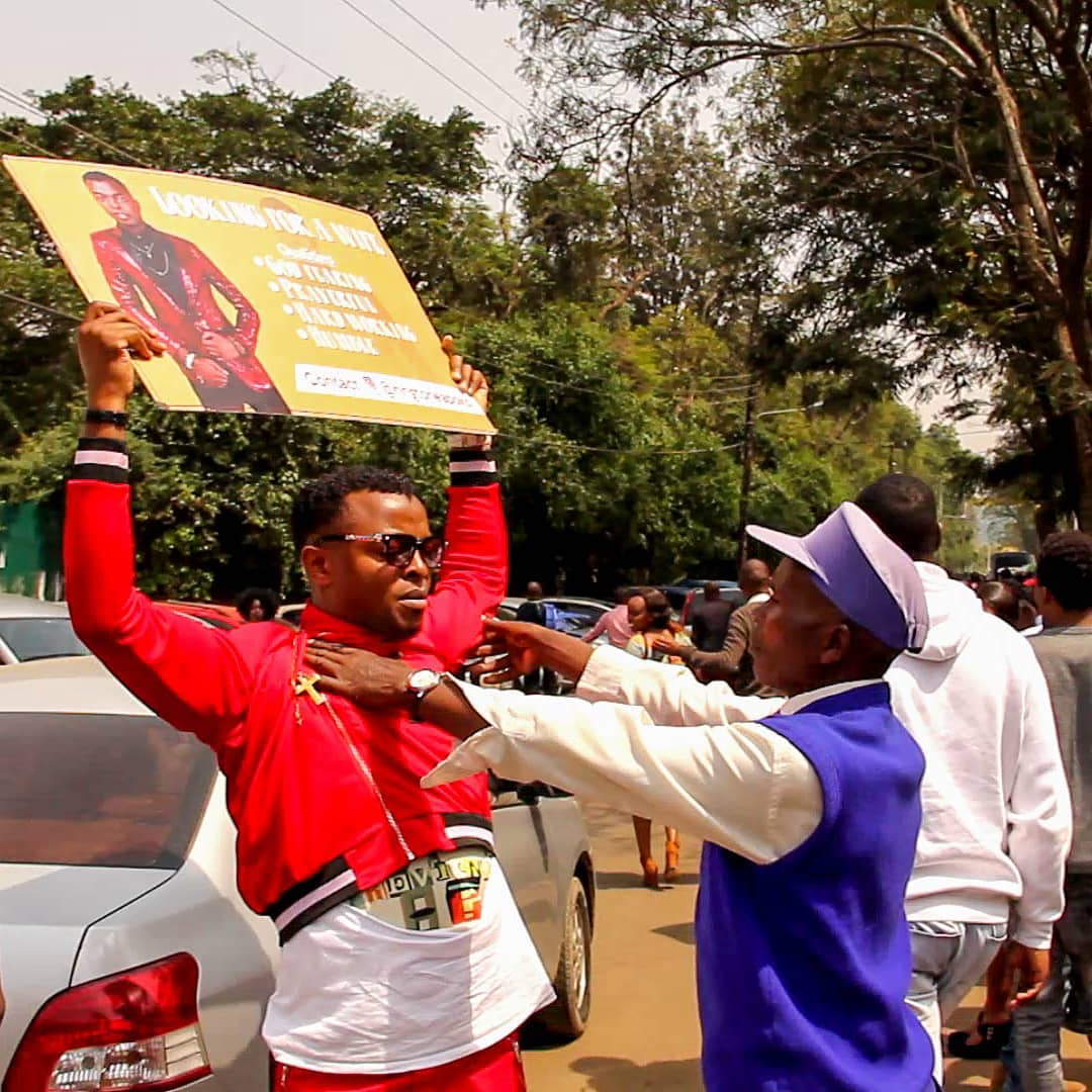 Ringtone holding his "Looking for a Wife" placard outside of Jubilee Christian Church, Parklands earlier on today. photo credit: Instagram/ringtoneapoko