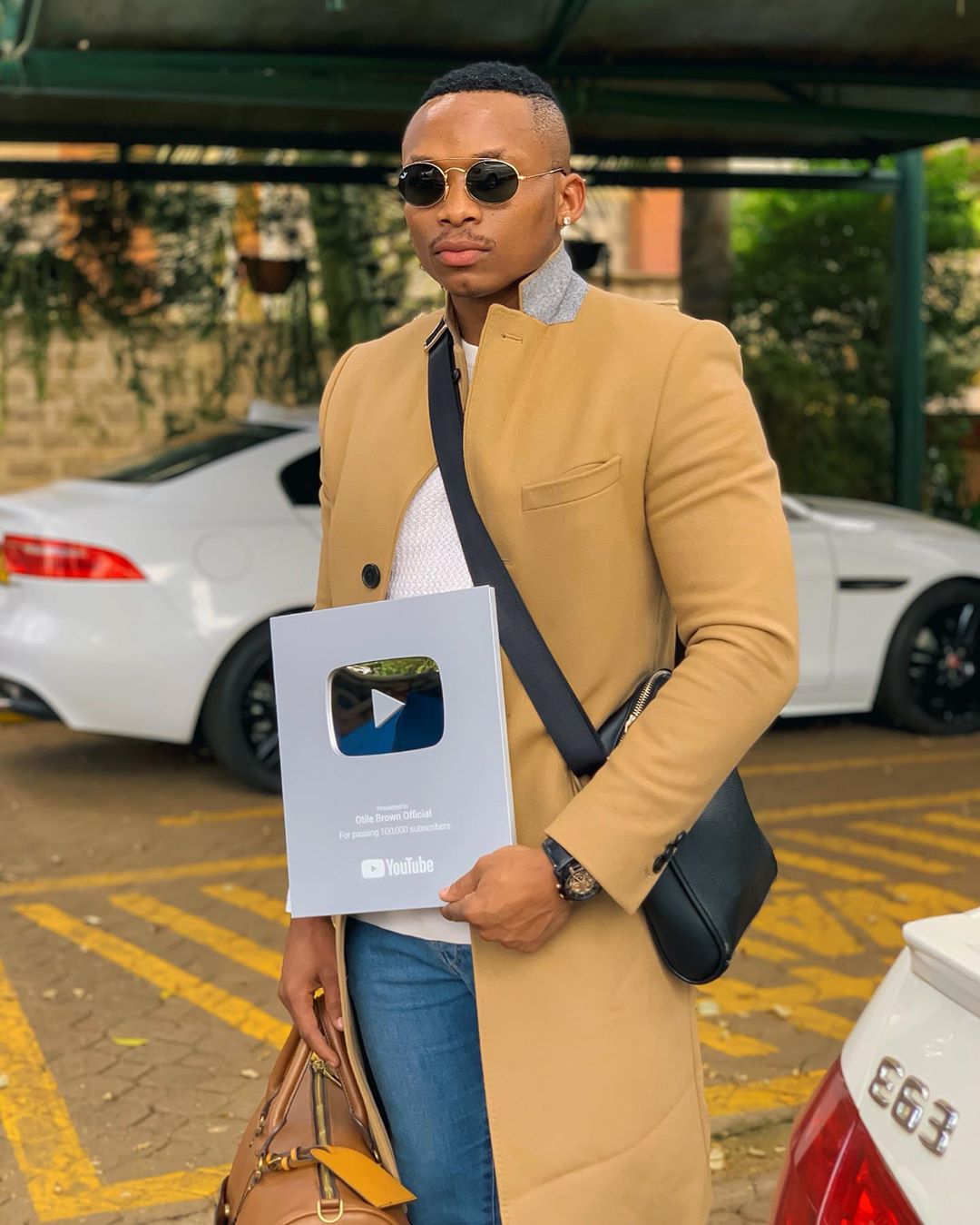 Otile Brown holding his YouTube plaque for reaching 100K subscribers. photo credit: Instagram/otilebrown