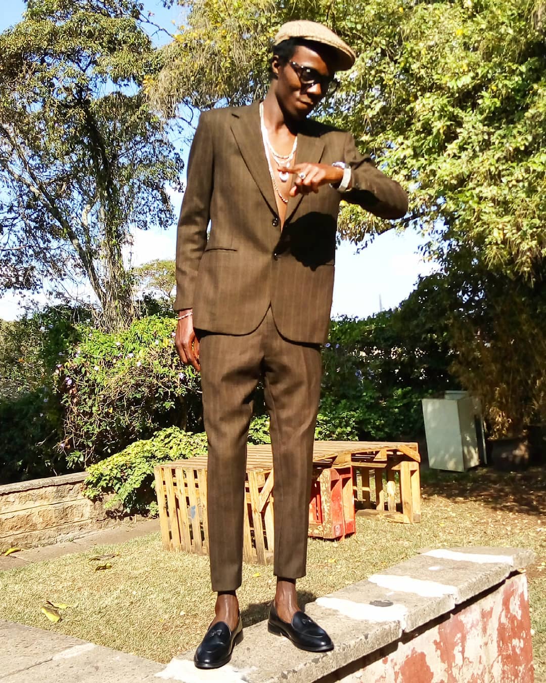 Zzero Sufuri rocking a fitting suit on set of the music video for 'Matiati' as shot and directed by Enos Olik. photo credit: zzero_sufuri/Instagram