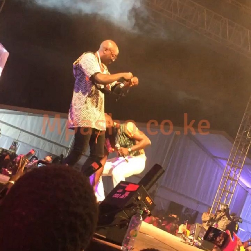 Willis Austin Chimano helping out Bien-Aimé Baraza wear the bras that his female fans were throwing at him showing him love. photo courtesy of Instagram/mpashogram