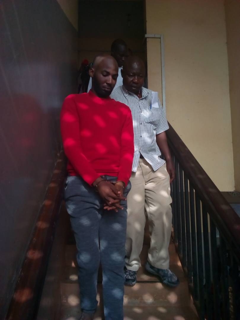 Godfrey Wamala being escorted out of court