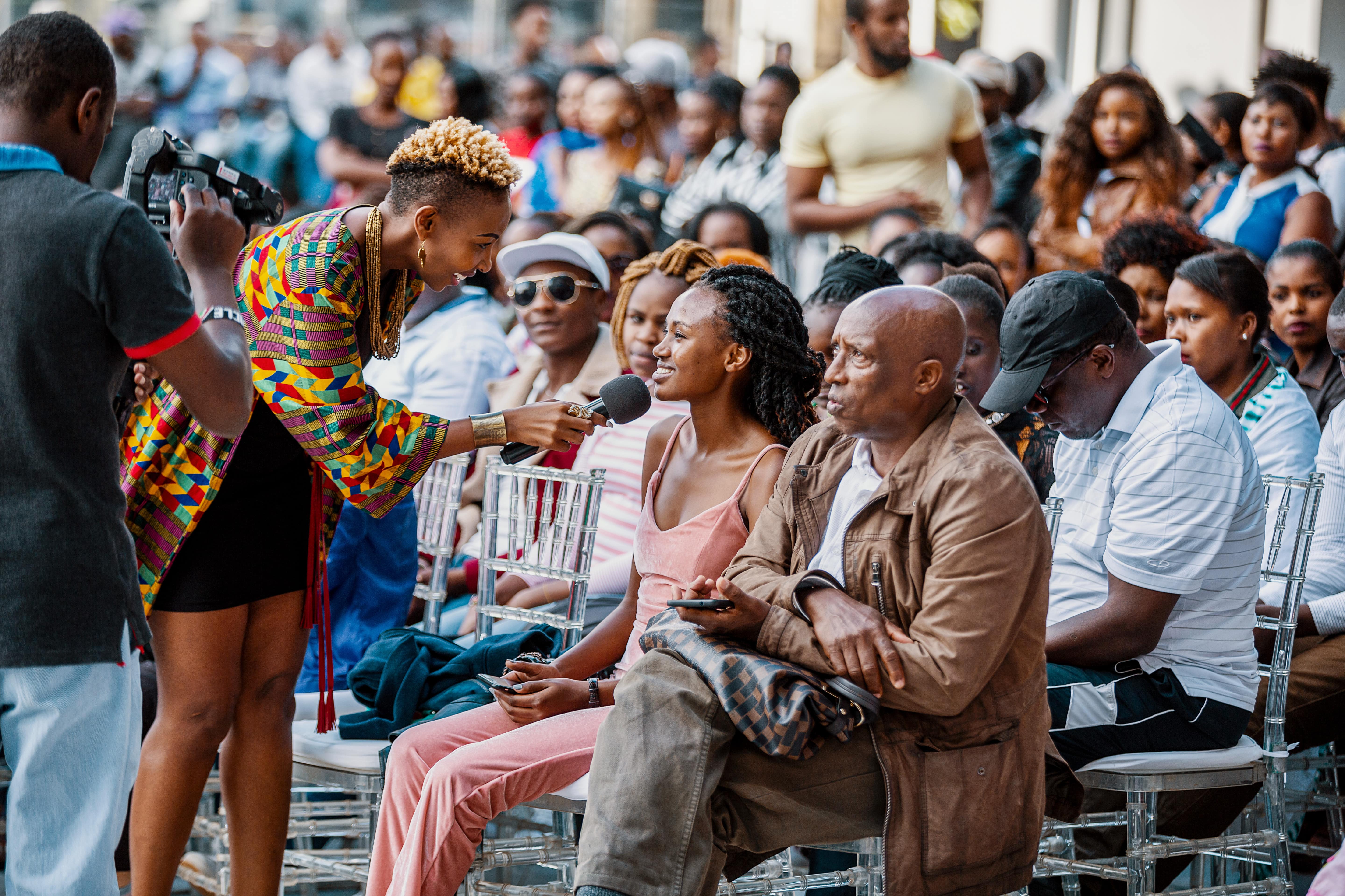 host of the event, Mwalimu Rachel talking with one member of the crowd at the event. photo credit: Laurent Bosire