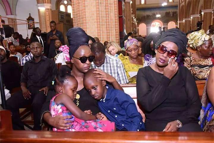 Lillian Mbabazi with her two children during a requiem mass for Mowzey Radio