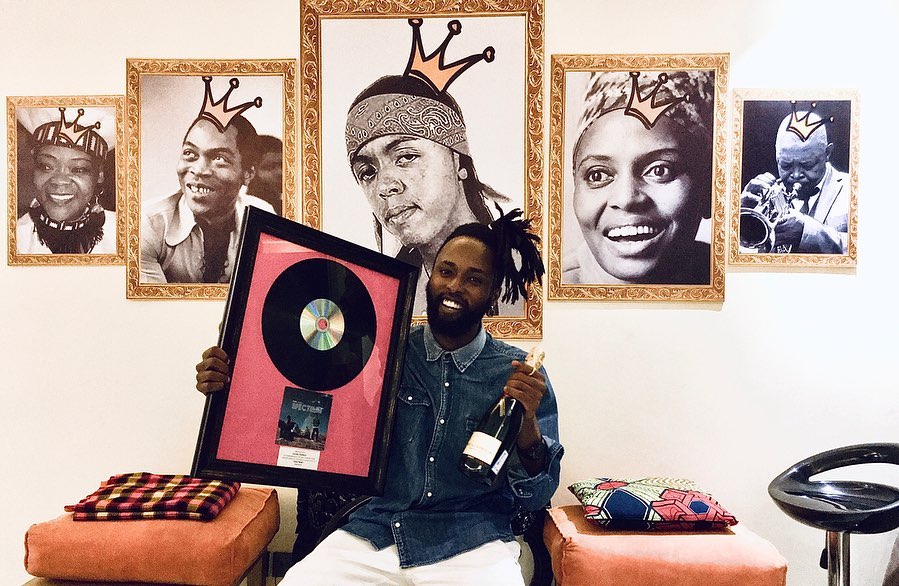 Kagwe Mungai holding his platinum plaque he got from his debut studio album 'Spectrum'. Photo credit: Instagram/kagwemungai