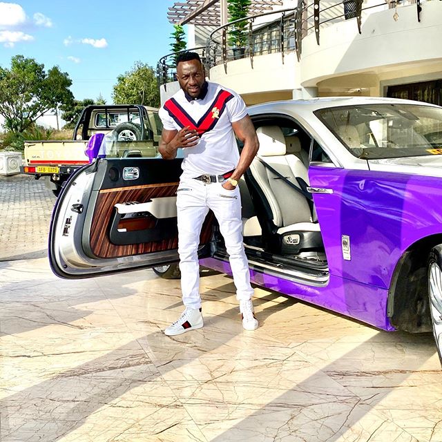 Genius Kadungure standing outside the Rolls Royce Wraith he was driving prior to the accident that claimed the lives of three people on 8, November, Sunday, morning. Photo credit: Instagram/ginimbi