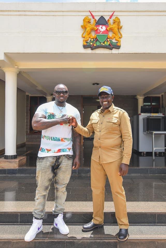 Khaligraph Jones and Deputy President William Ruto fist-bumping together. Photo credit: Twitter