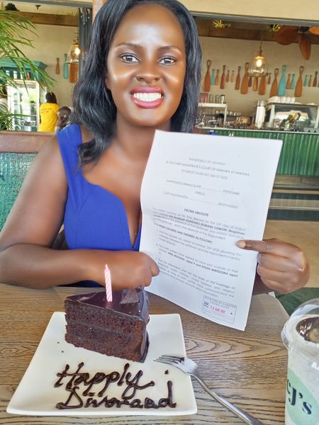 Nantongo Immaculate holding her official divorce papers as she celebrates getting divorced after being a marriage that brought forth two children. Photo credit:Instagram/Nantongo Immaculate