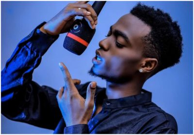 An elderly traditional man stops rain at a funeral in Kumasi