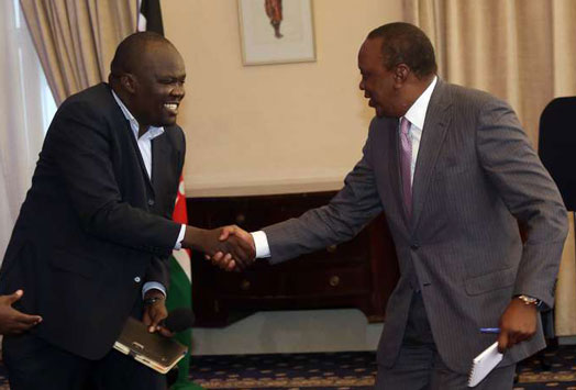 President Uhuru Kenyatta shakes hands with blogger Robert Alai during the State House Energy Summit at State House in Nairobi on July 27, 2016. Photo credit: Evans Habil