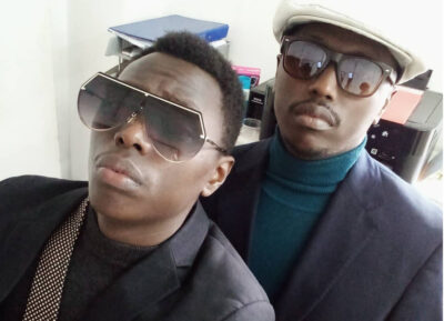 Michelle Ntalami unveils thigh tattoos on a beach