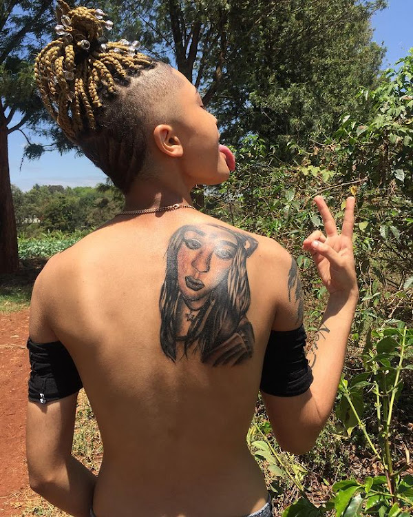 King Alami proudly showing off her Noti Flow's back tattoo. She also had Noti Flow's name tattooed on her right arm. Photo credit: Courtesy