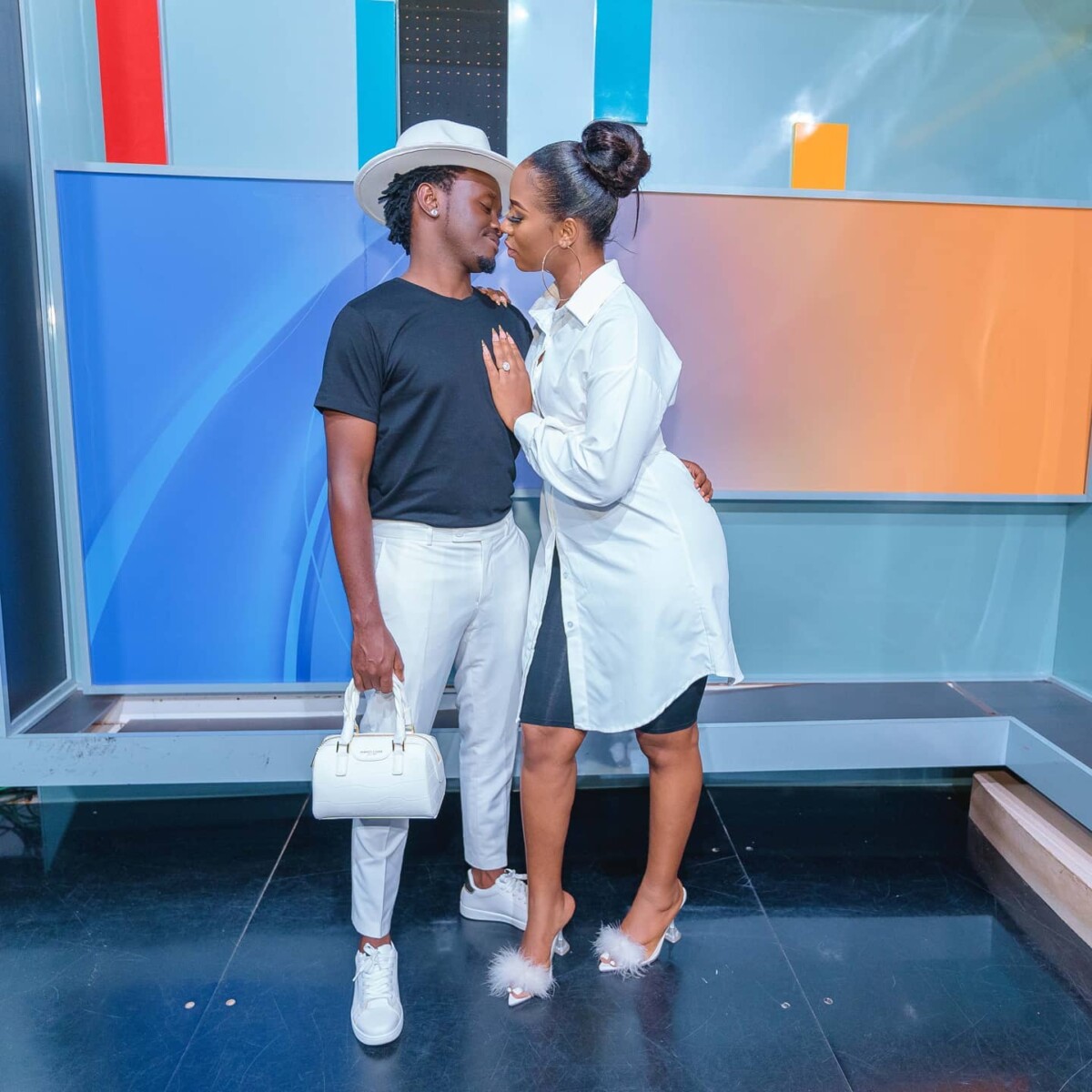 Singer Bahati carrying Diana Marua's handbag, his wife.