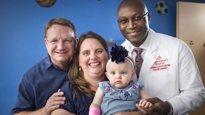 Dr. Oluyinka Olutoye poses with the parents and the baby he operated on. PHOTO/X/@Afrika_Stories